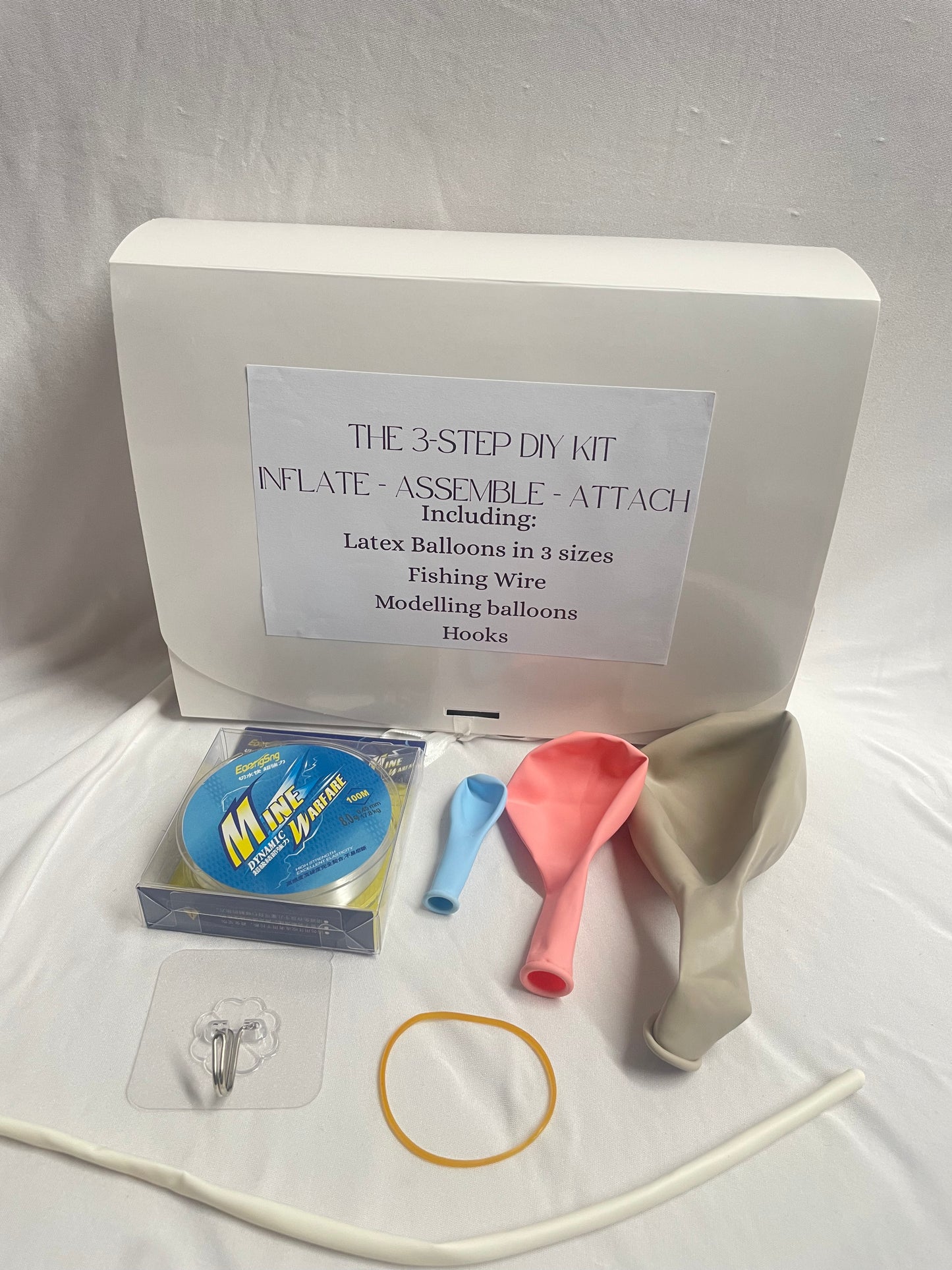 3-step DIY kit with balloons, fishing wire, and other supplies on a white background