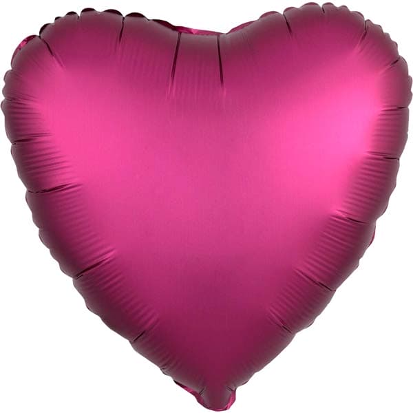 Pink heart-shaped balloon on a white background